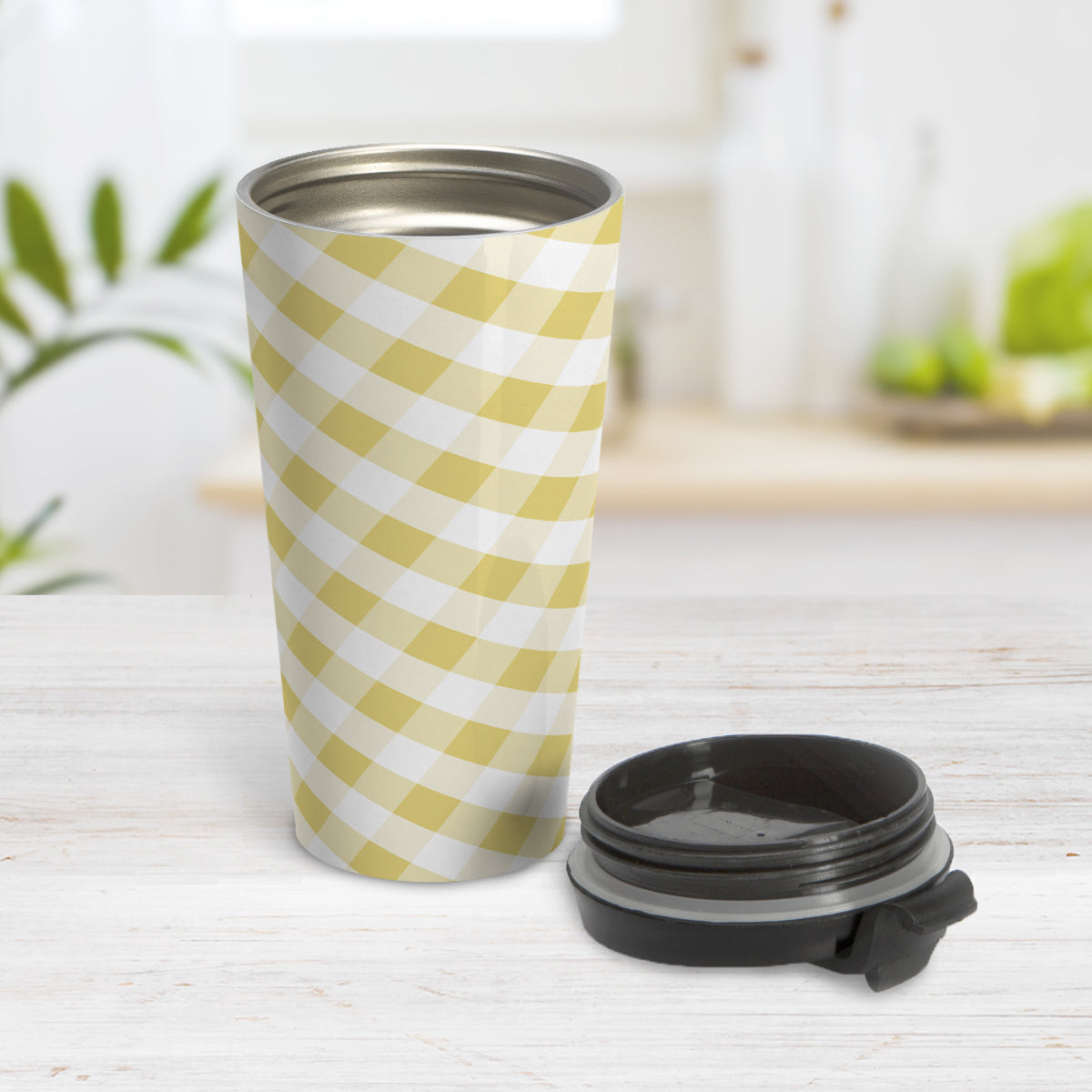 Yellow Gingham Travel Mug (15oz) at Amy's Coffee Mugs. A travel mug designed with a slanted yellow gingham pattern in yellow and white that wraps around the travel mug. Photo shows the mug open on a table with the lid on the table beside it.